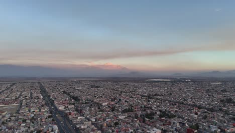 aerial view of the ecatepec area, with the volcanoes in the background, mexico city