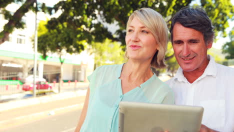 smiling couple using tablet