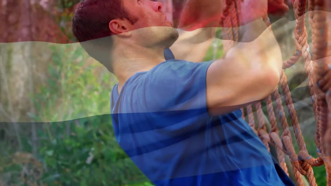 animación de la bandera de los países bajos sobre un hombre fuerte y musculoso escalando