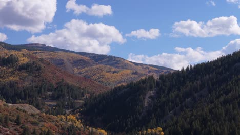 Parallax-drone-shot-of-fall-mountains,-70mm