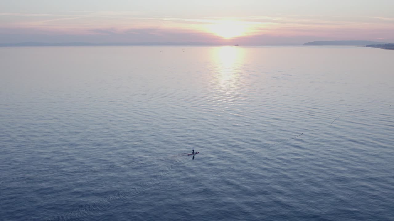 Drone shot of a paddle boarder gliding on the Adriatic at sunset, Split, Croatia