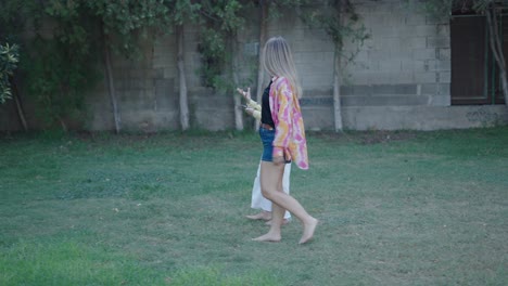 women walking barefoot in a garden