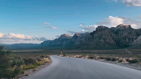 desert road winding through red rock mountains