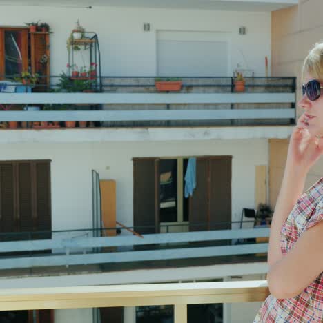 A-woman-in-sunglasses-in-a-hotel-talking-on-the-phone