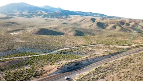 Desert-Highway-at-sunset-and-dusk-with-a-snake-river-and-plateaus-from-a-drone-in-1080p-summer-of-2018