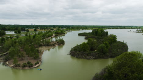 Shelby-farms-park-with-lush-greenery-and-serene-lake,-aerial-view