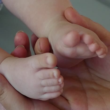 mother hands and baby feet