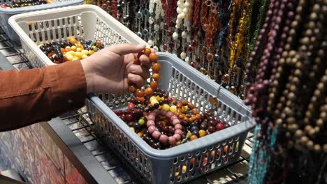 high angle shot of man looking at bracelets