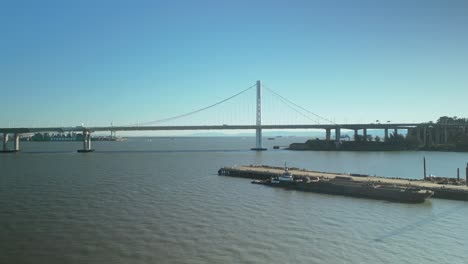 push in drone shot of san francisco-oakland bay bridge with sunny weather in california, usa