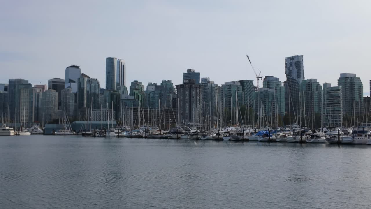 Gimbal wide panning shot of Coal Harbour on an autumn afternoon in Vancouver, British Columbia, Canada. 4K