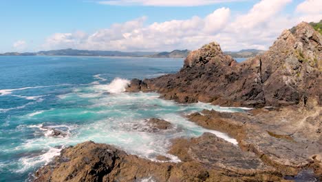 aerial drone flying close to sharp rocks on the shore