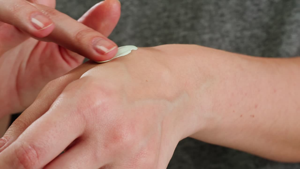 aplicación de crema verde claro en la muñeca