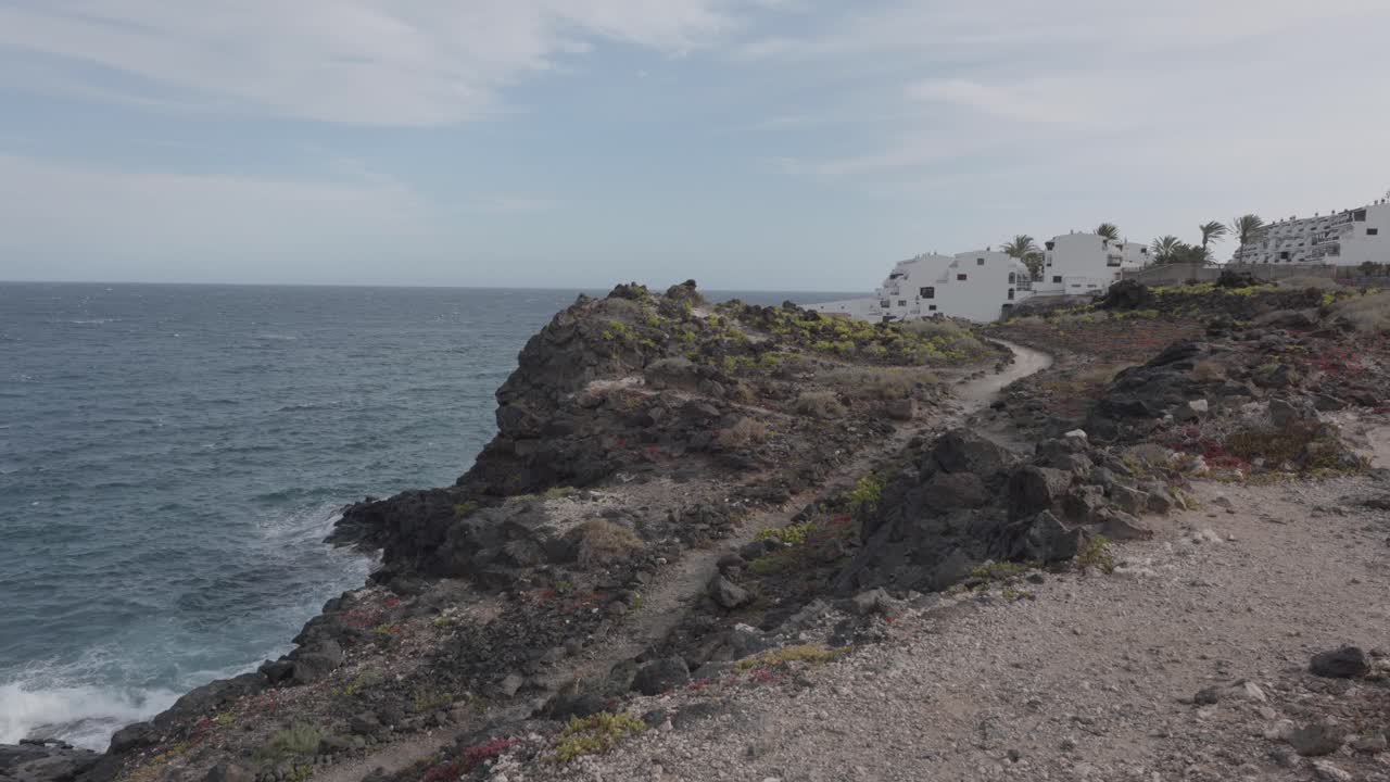 Buildings by the coast and ocean in a village in Los Abrigos, Tenerife, Canary Islands, Spain.