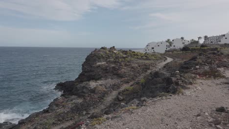 buildings by the coast and ocean in a village in los abrigos, tenerife, canary islands, spain.