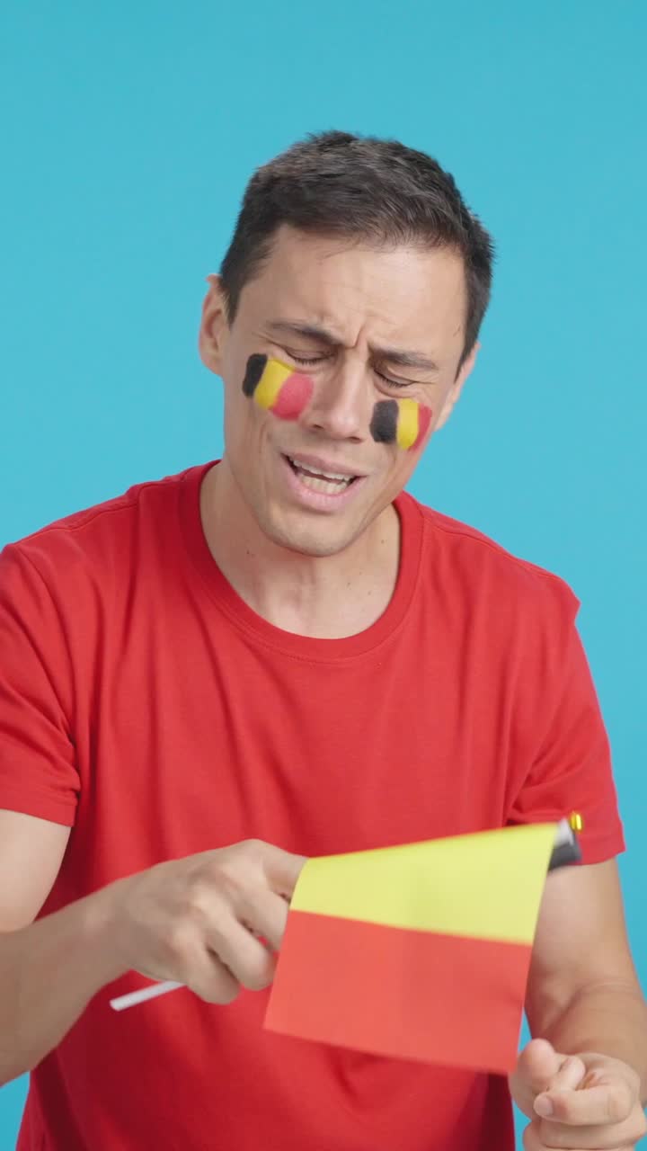Man cheering for Belgium during a match that is lost