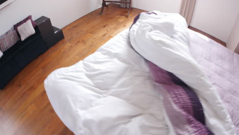 point of view of man making bed up in the morning