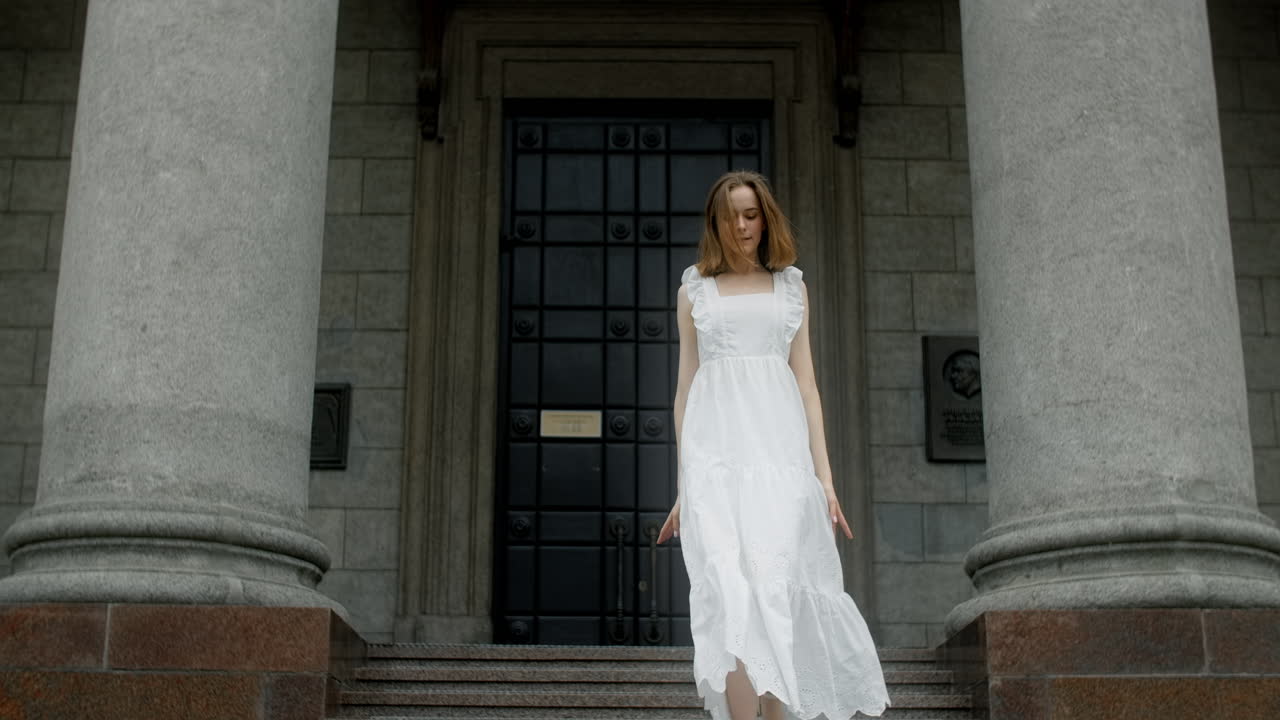 Ballet Dancer in White Dress at Architectural Building