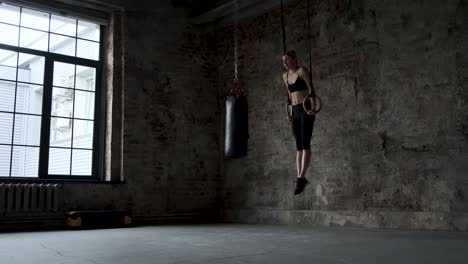 women doing ring dips and working hard in the box gym