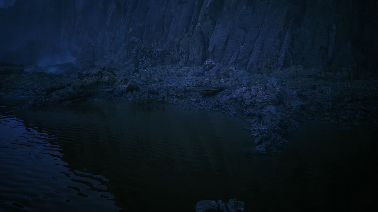 Peaceful water reflection amidst rocky shoreline and gentle fog