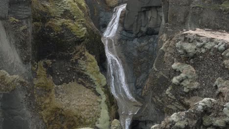 stream of water falling through rocks at fjadrargljufur canyon, iceland