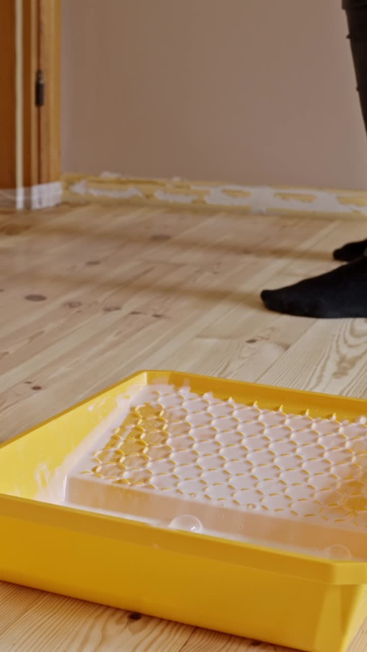 Varnishing hardwood floor during renovation. Indoor craftsmanship scene