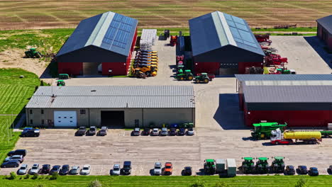 industrial farm equipment storage facility hangars warehouse, aerial drone above