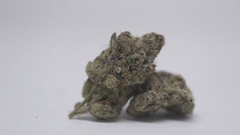 a pile of cannabis buds on a white background