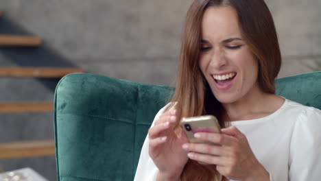 business woman getting great news on smart phone in remote office.