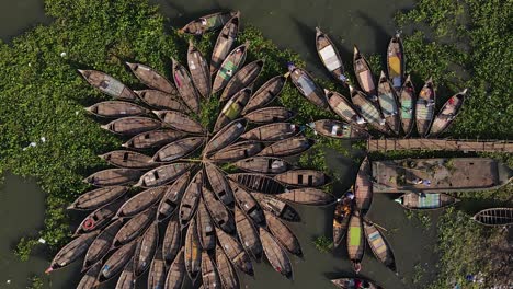 aerial descends to an array of traditional ghat wooden boats - bangladesh