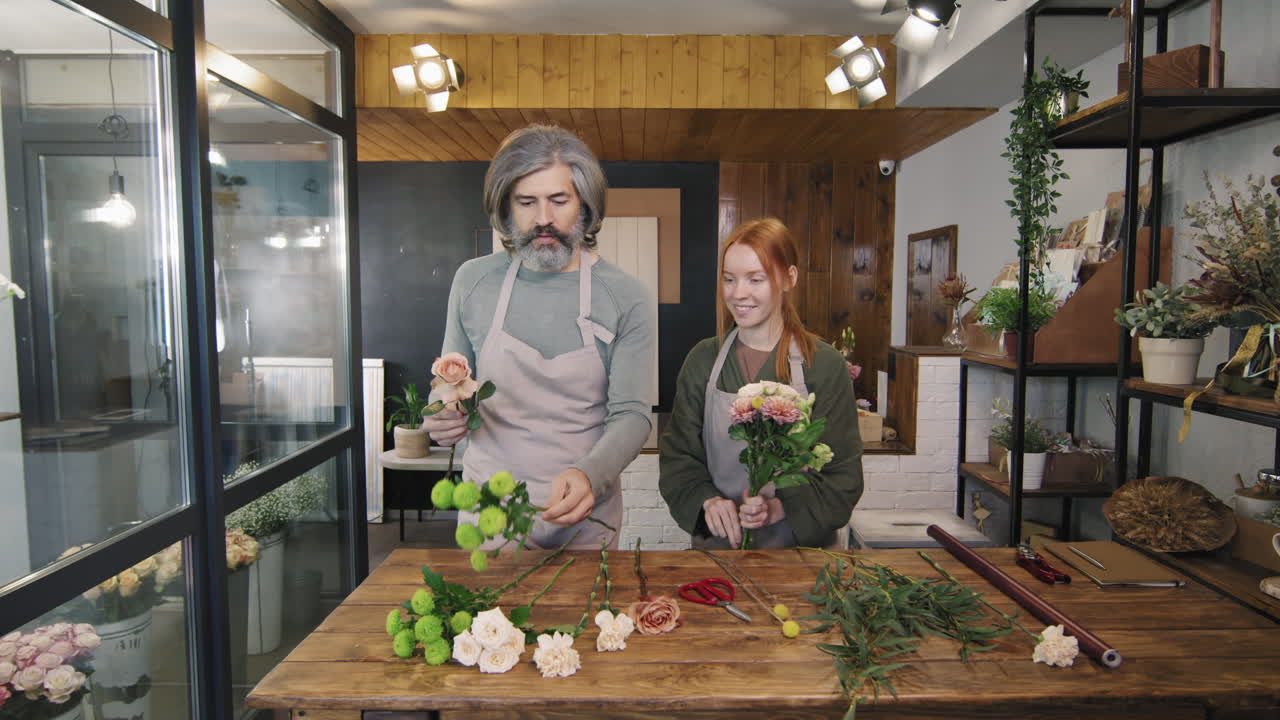 Florists Arranging Flowers In Gentle Bouquet