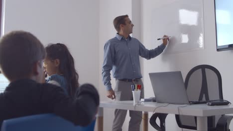 male school teacher drawing on whiteboard