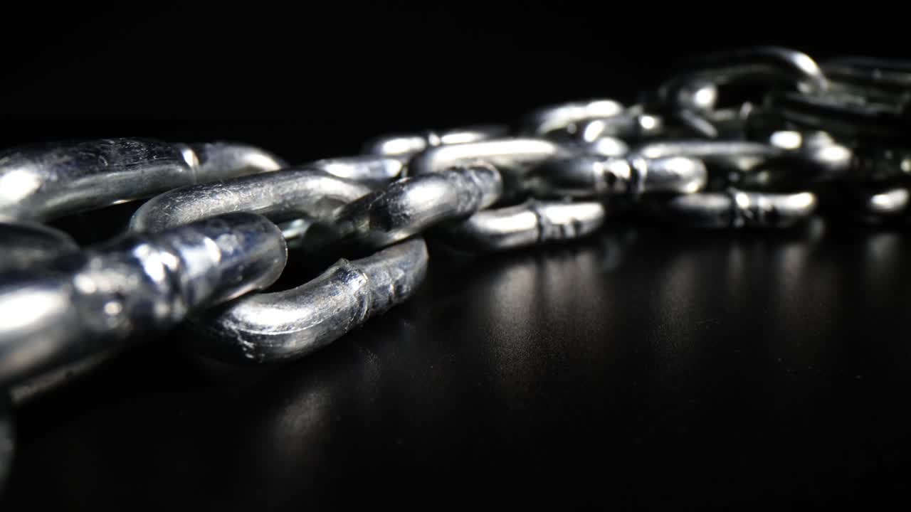 Close-up of a Silver Metal Chain on a Dark Background