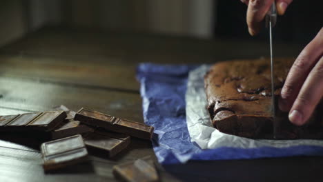 chef cutting chocolate dessert on table. slicing chocolate cake.