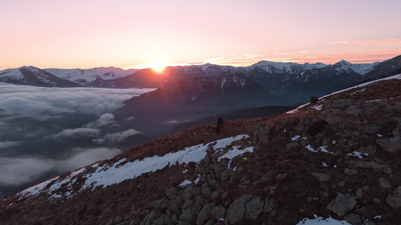 Sunrise hiker on snowy mountain, peaceful solitude, scenic view