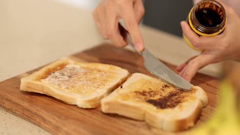 making toast with vegemite