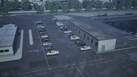 aerial view of a parking lot next to a building and a body of water