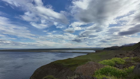 timelapse footage showing clouds flowing past a dramatic cliff formation near húsavík in northern iceland