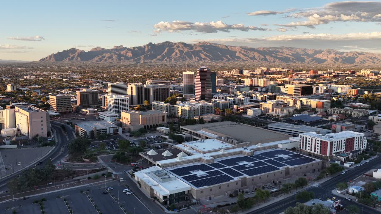 Long wide push towards downtown Tucson, Arizona by drone with Catalina Mountains in background