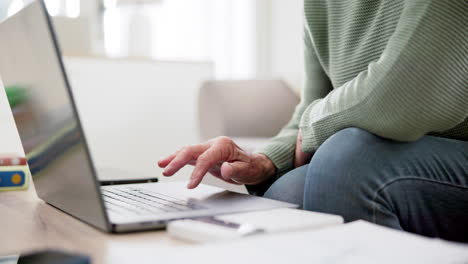 Person-hands,-calculator-and-laptop-on-sofa