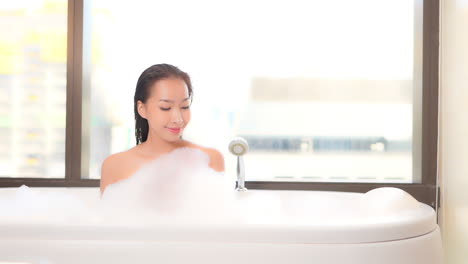 gorgeous stoic asian beauty bubble bathing