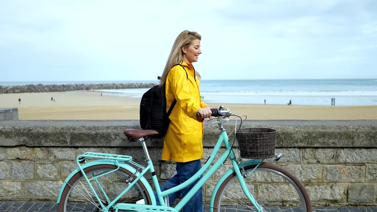 Woman with Bicycle on Beach Coast