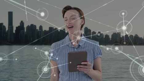 Animation-of-caucasian-businesswoman-using-tablet-and-network-of-connections-over-cityscape