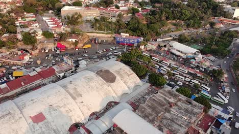 mercado adolfo lópez mateos in cuernavaca, mexico, showing bus terminals, market stalls, and bustling urban activity. drone aerial view
