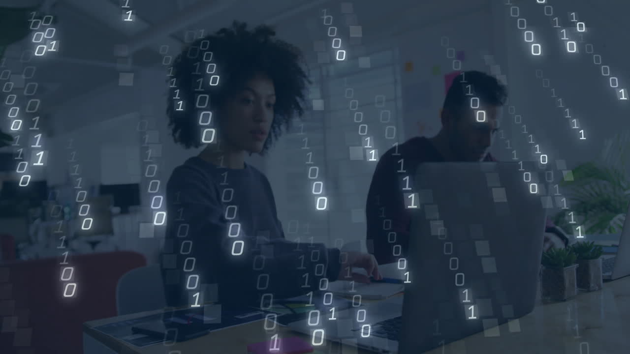 Binary code animation over diverse people working on laptops in office