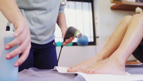 physiotherapist giving leg massage to a boy 4k