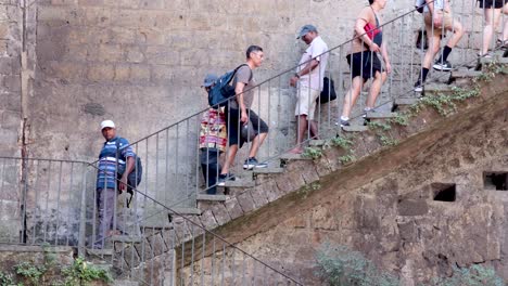 tourists ascending outdoor stairs in sorrento, italy