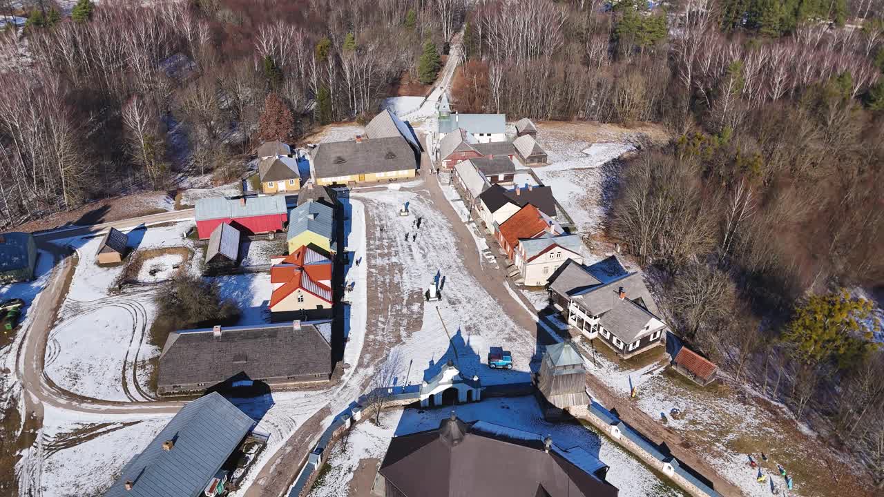 Historical snow covered township on sunny winter day, aerial view