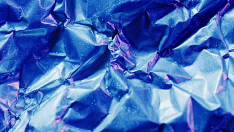 animation of flash sale text over close up of blue crumpled paper
