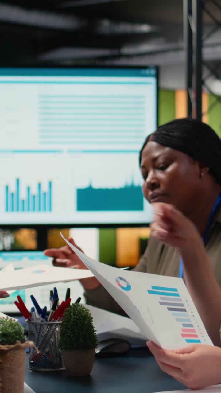 Vertical Video Empowered group of women strategizing together with data reports