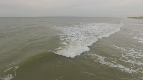 Aerial:-An-overcast-day-at-the-sand-beach-between-Domburg-and-Westkapelle,-the-Netherlands